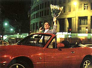 A car, flowers and a telephone